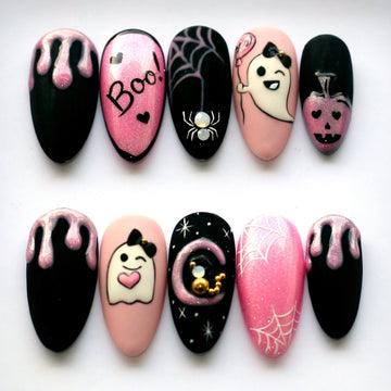 Handmade Halloween press-on nails with ghost, spider, pumpkin, and pink glitter designs
