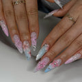 Long stiletto press-on nails with 3D pink flowers, pastel ombré, rhinestones, and intricate design