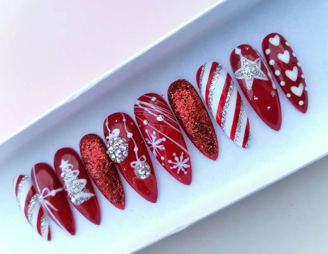 Red Christmas press-on nails with glitter, snowflakes, stripes, and festive holiday designs.