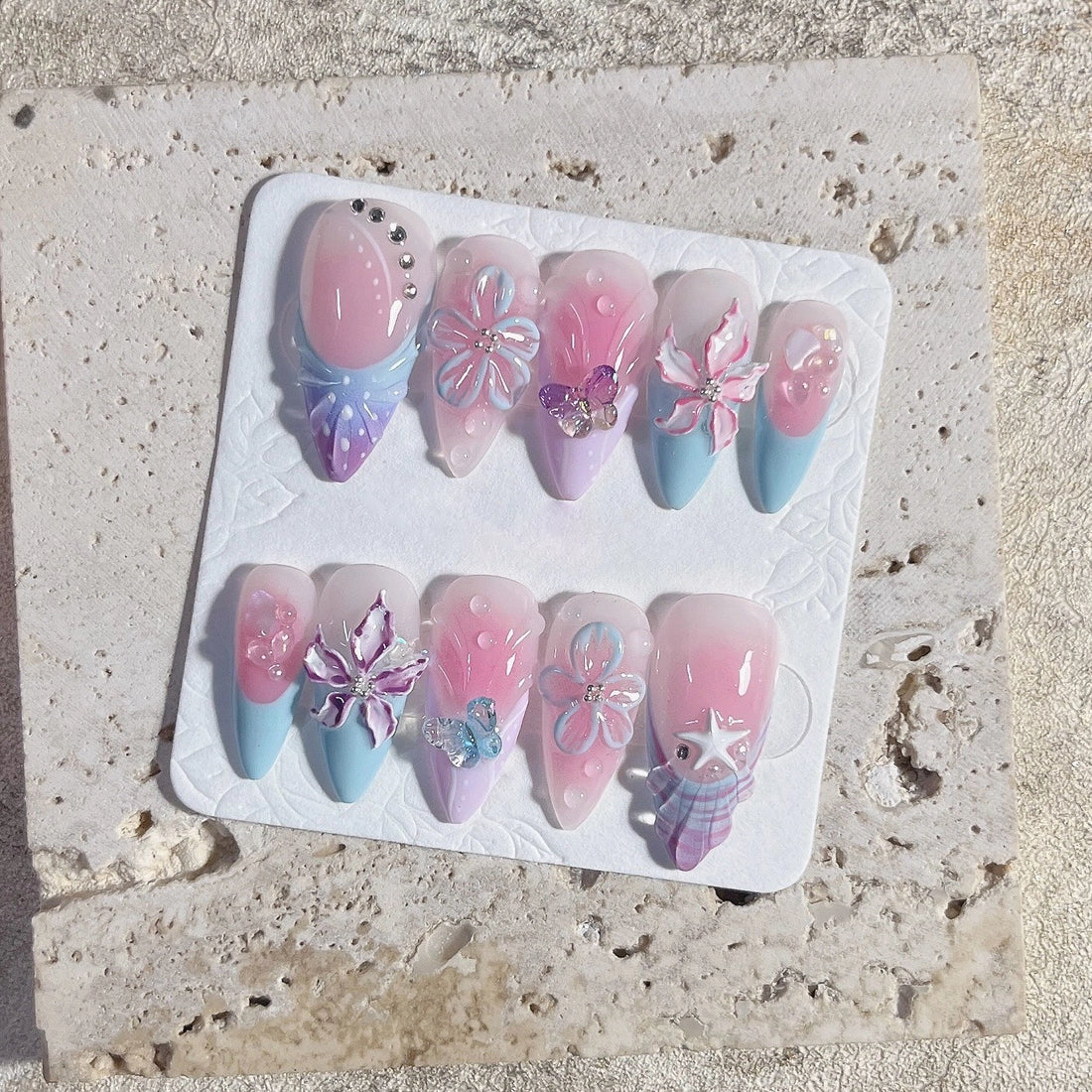 Handmade pastel press-on nails with 3D butterfly, floral, and ribbon bow designs