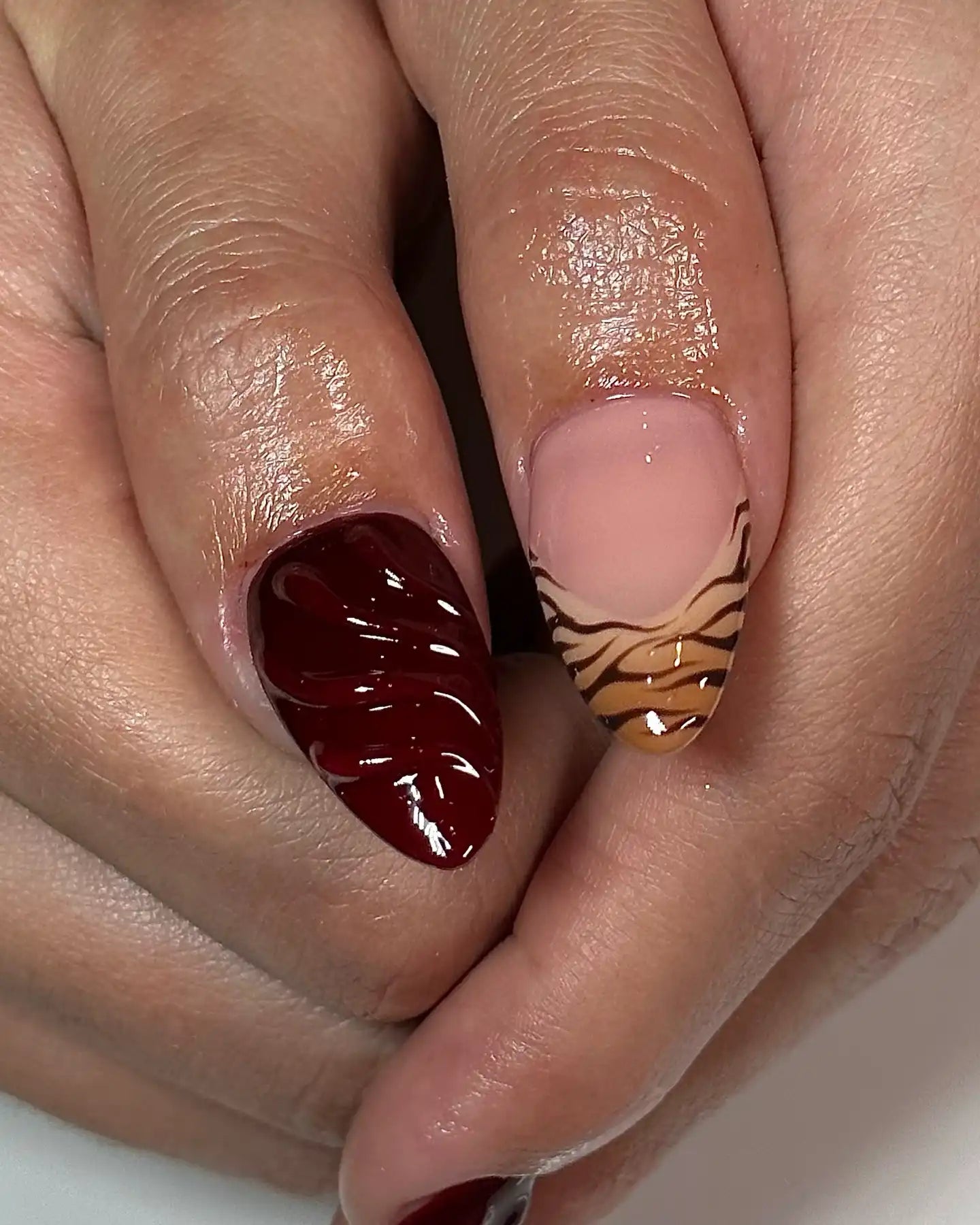 Hand with handmade 3D cherry chocolate brown and animal print press-on nails