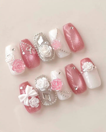 Handmade pink and white coffin press-on nails with 3D rose, bow, and rhinestone accents.