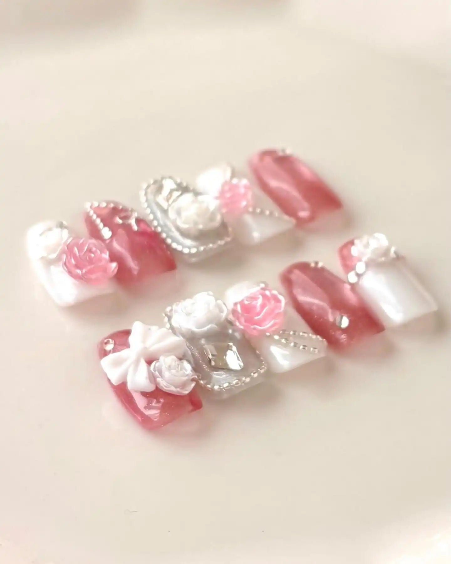 Handmade pink and white 3D rose coffin press-on nails with bow and pearl accents