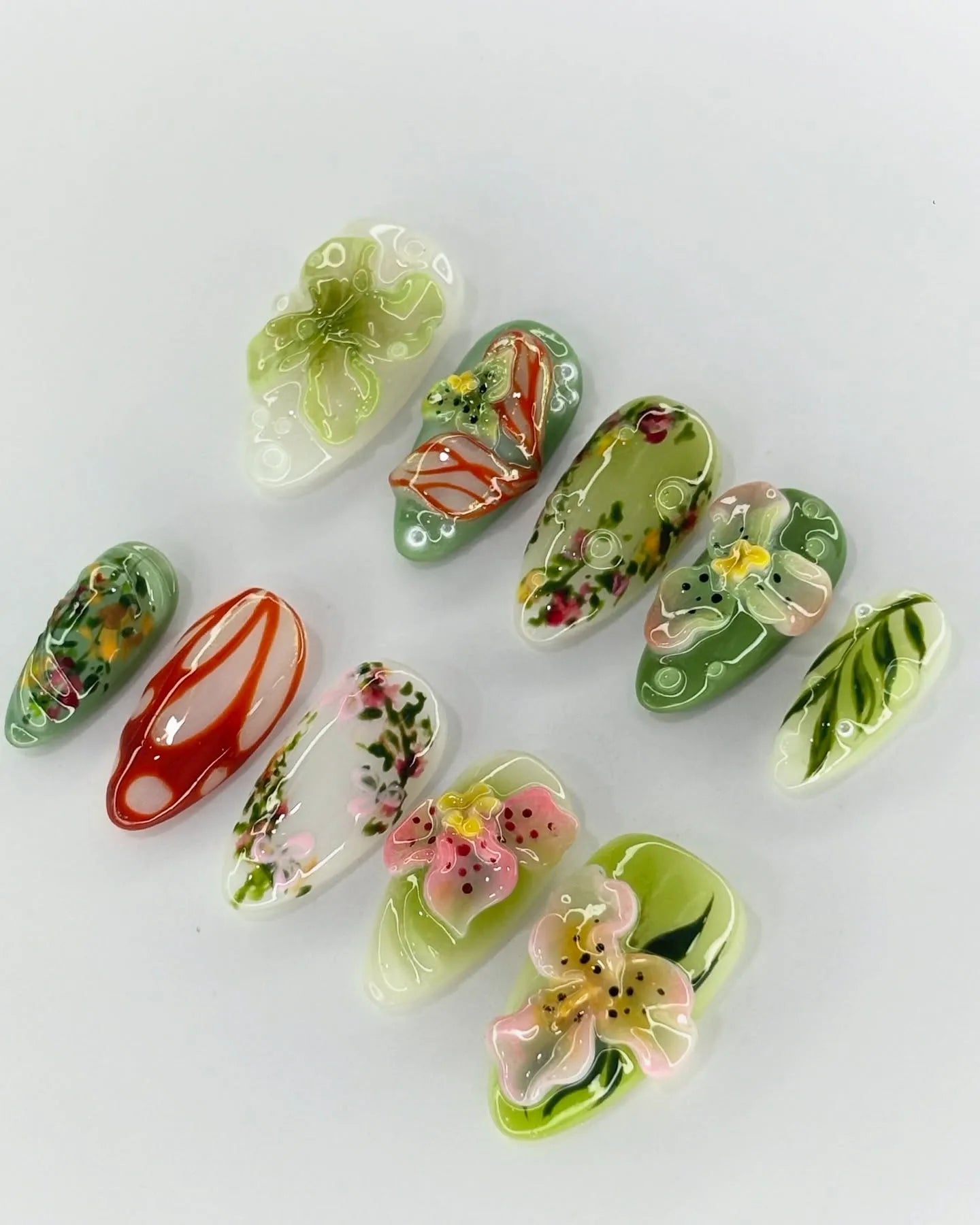 Handmade 3D press-on nails with tropical orchid, lily, and green floral designs