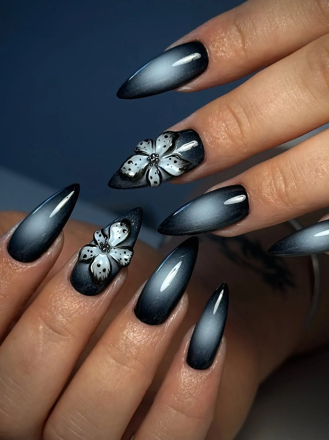 Handmade black press-on nails with 3D floral design and glossy ombre finish