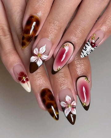 Handmade press-on nails with cherry, brown, white floral designs and gold accents.