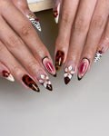 Handmade press-on nails with cherry blossom design, tortoiseshell, zebra print, and gold accents.