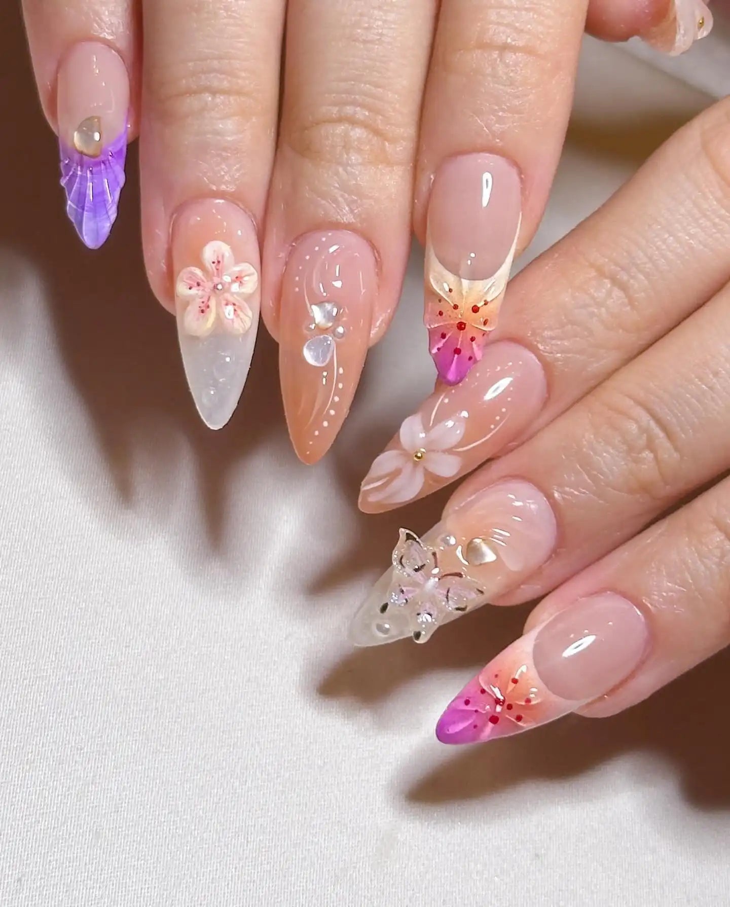 Handmade press-on nails with 3D butterfly, flower accents, and pastel mermaid designs