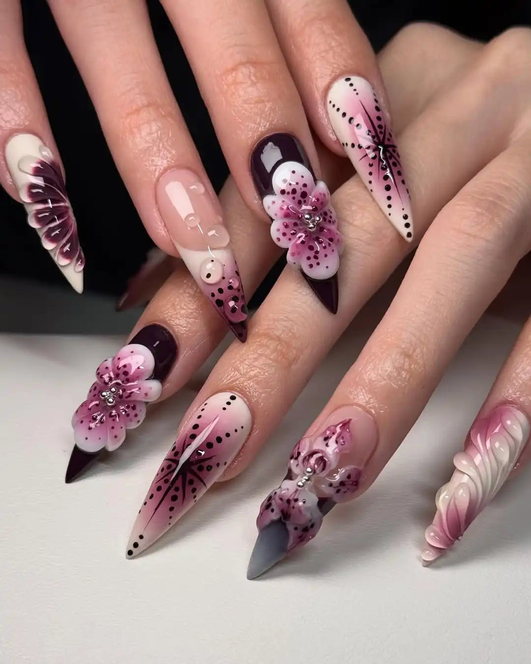 Handmade press-on nails with purple 3D floral designs and rhinestone accents