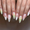 Handmade press-on nails with French tips, floral and strawberry designs, pastel colors, 3D flower accent.
