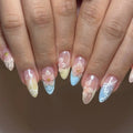Handmade press-on nails with pastel ombre, 3D pink blossom flowers, and seashell accents.