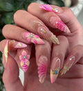 Handmade press-on nails with pink 3D floral and seashell designs, crystal accents, glossy finish.