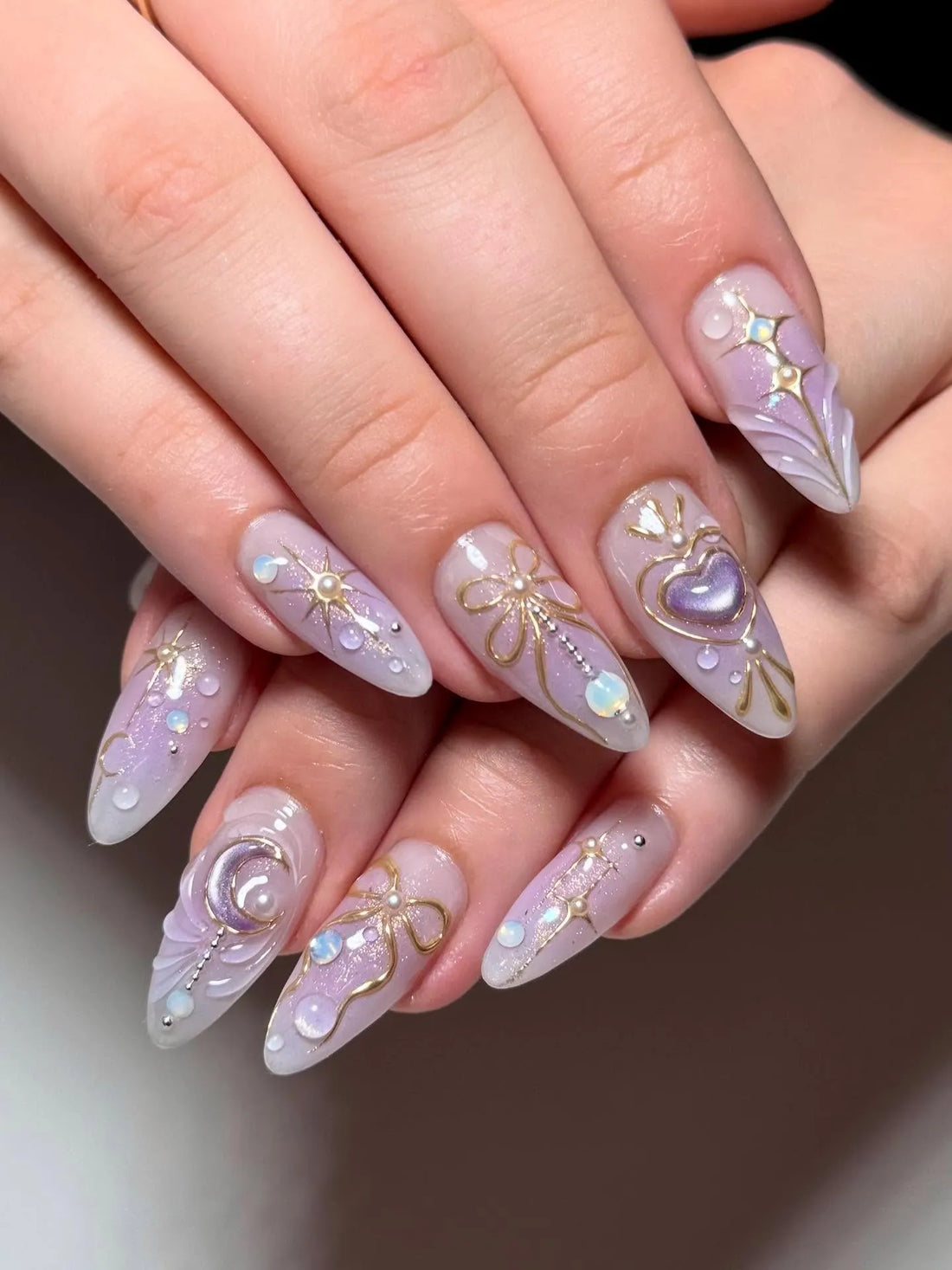 Handmade purple stiletto press-on nails with celestial gold accents and heart designs