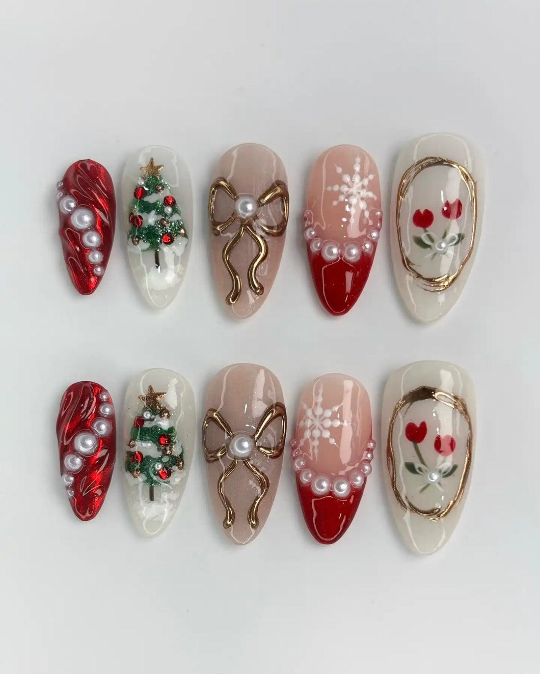 Handmade festive press-on nails with Christmas tree, bow, pearl, and red white holiday designs