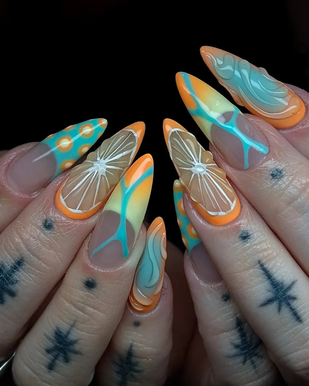 Handmade press-on nails with citrus orange slices, aqua swirls, and retro summer patterns