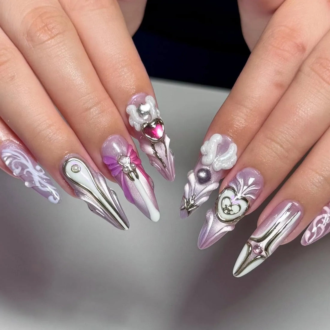 Handmade iridescent pink metallic press-on nails with 3D heart, star, and bow designs