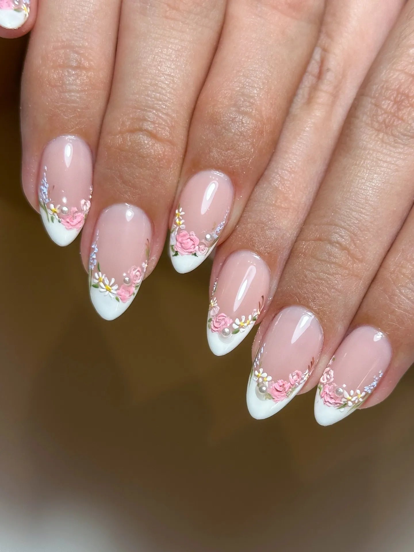 Handmade press-on nails with pearl white French tips and pink floral garden design.