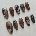 Handmade press-on nails with dark academia floral and butterfly designs in brown and gray tones.
