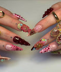 Handmade deep red 3D floral press-on nails with gemstones and artistic detailing