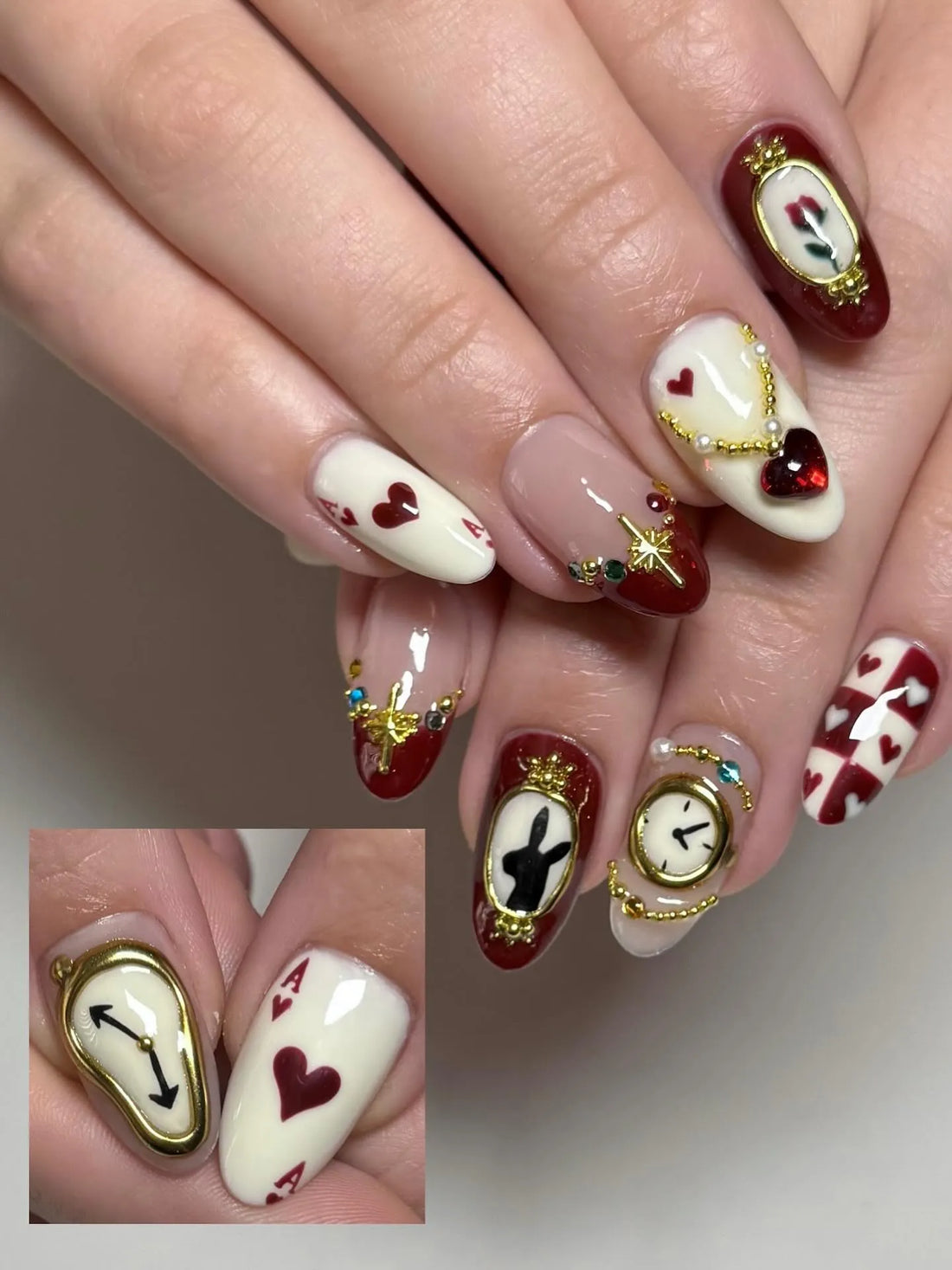 Handmade fantasy Wonderland press-on nails with clock, heart, and card designs in red and gold.