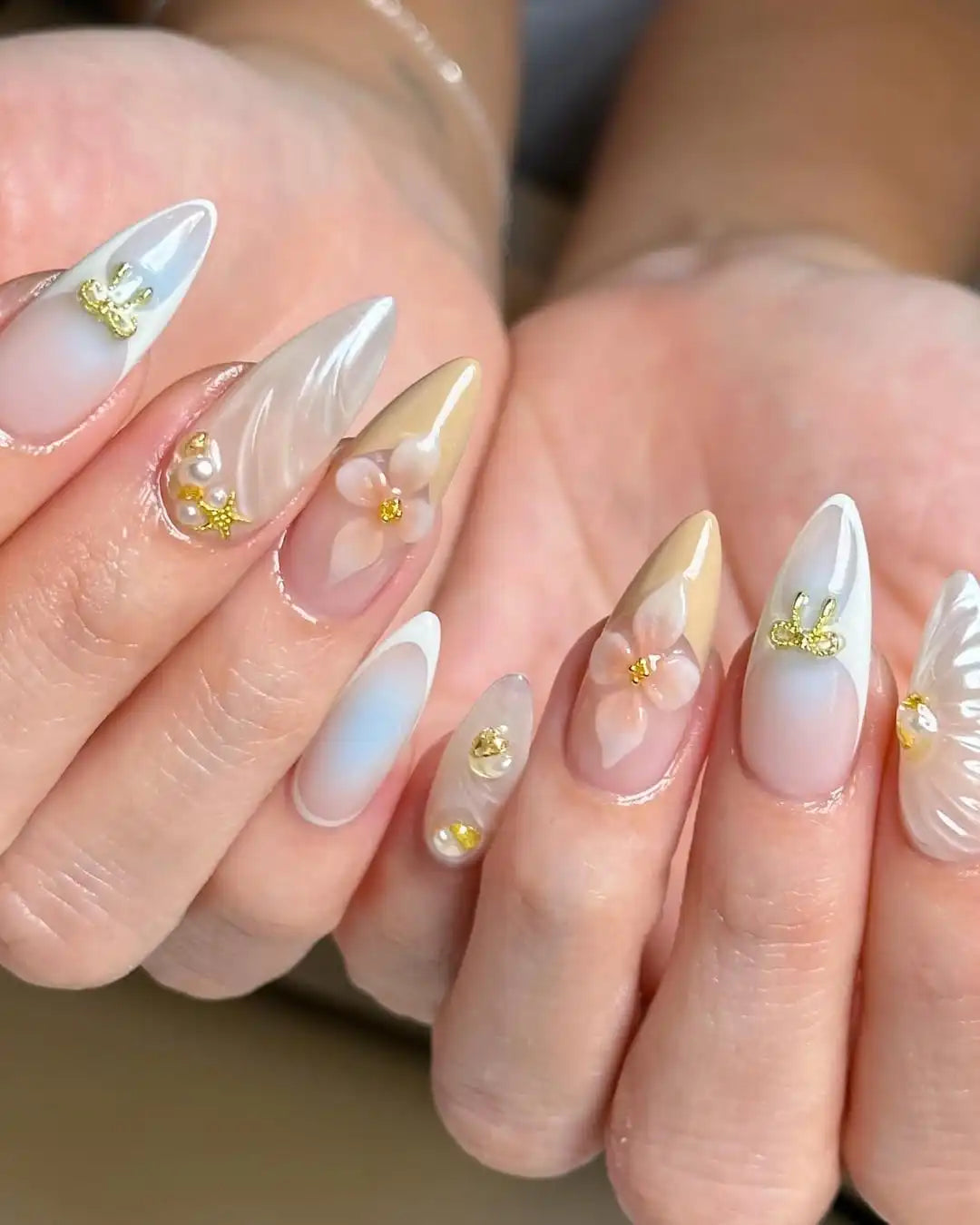 Handmade floral press-on nails with white French tips, gold accents, and 3D flower designs