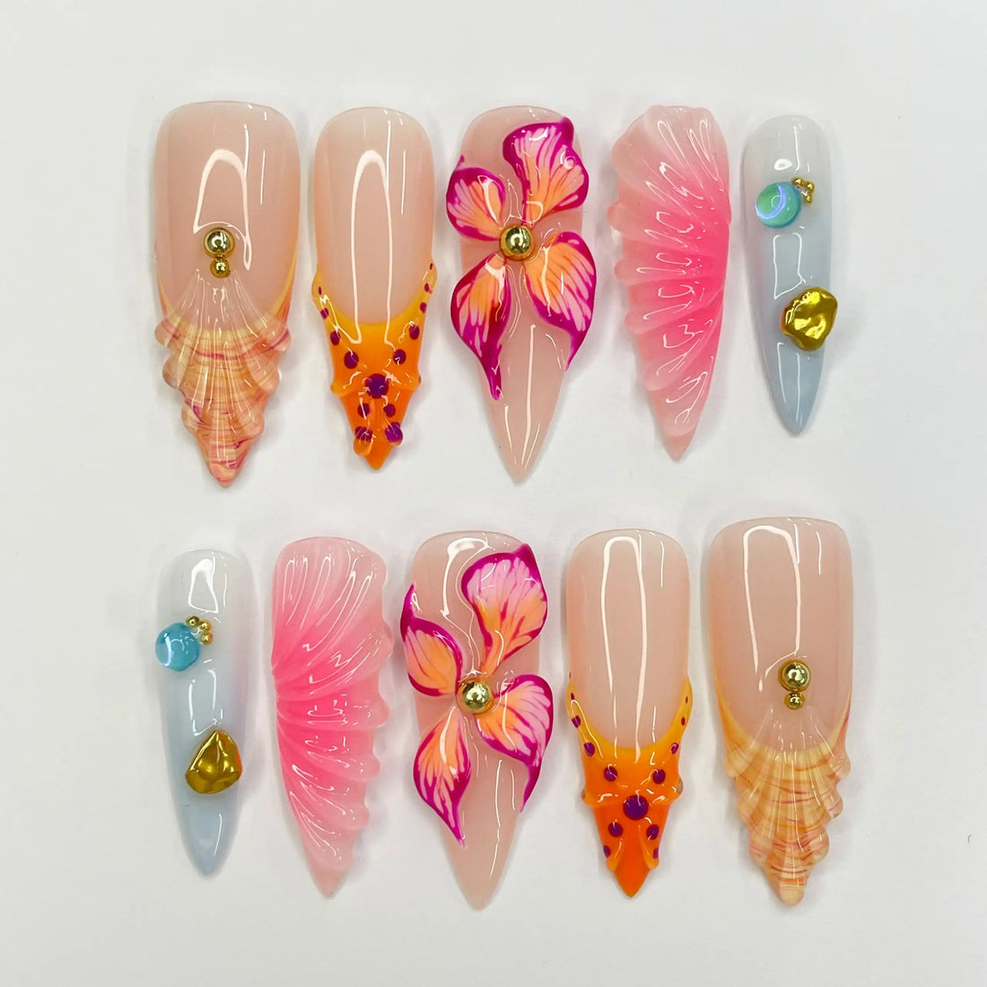 Handmade tropical press-on nails with pink, orange flowers, seashell and gem accents