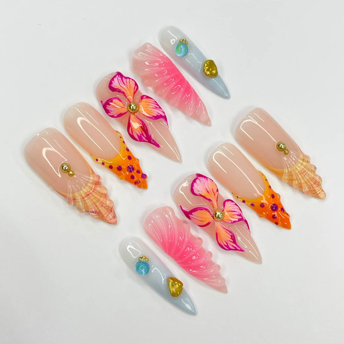 Handmade tropical press-on nails with pink, orange flowers, seashell and gem accents