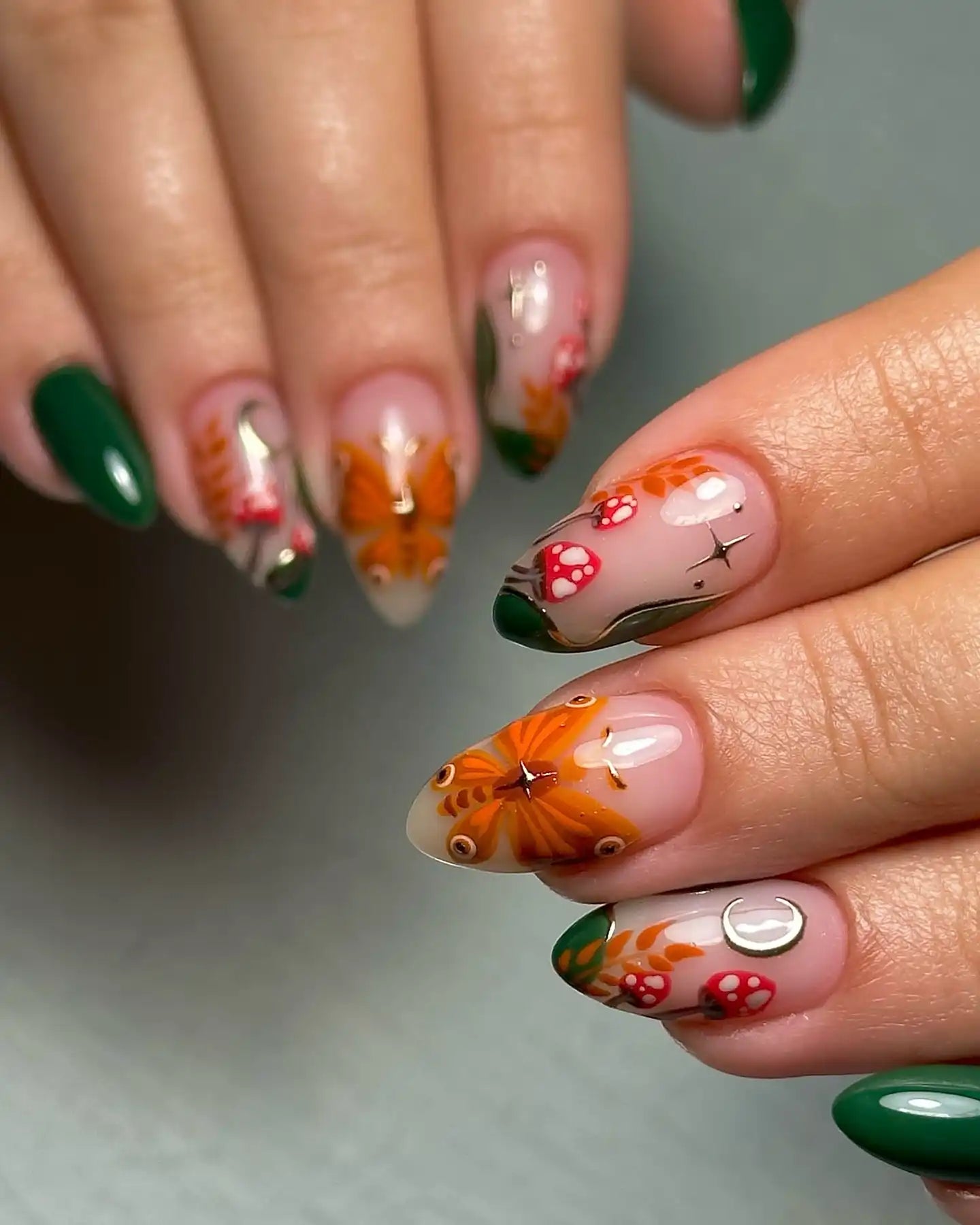 Handmade press-on nails with orange butterfly, red mushroom, moon, and green forest autumn designs
