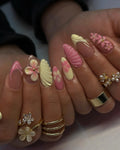 Handmade pink and yellow 3D flower press-on nails with sculpted shell designs, spring style