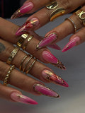 Hot pink ombre press-on nails with gold chrome details and sacred heart accents