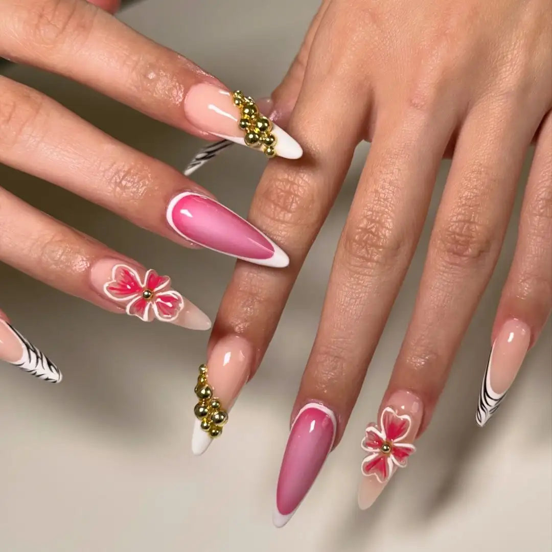 Handmade gold floral French tip press-on nails with pink accents and 3D flower designs