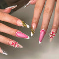Handmade gold floral French tip press-on nails with pink and white flower accents