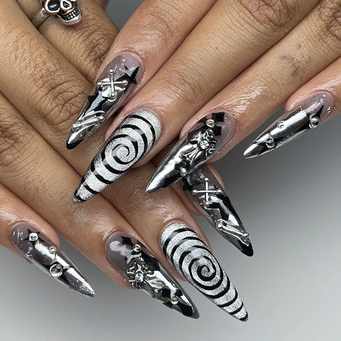 Handmade gothic chrome press-on nails with black, white spiral and 3D abstract designs