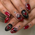 Handmade gothic press-on nails with red heart, flame, and silver chrome accents.