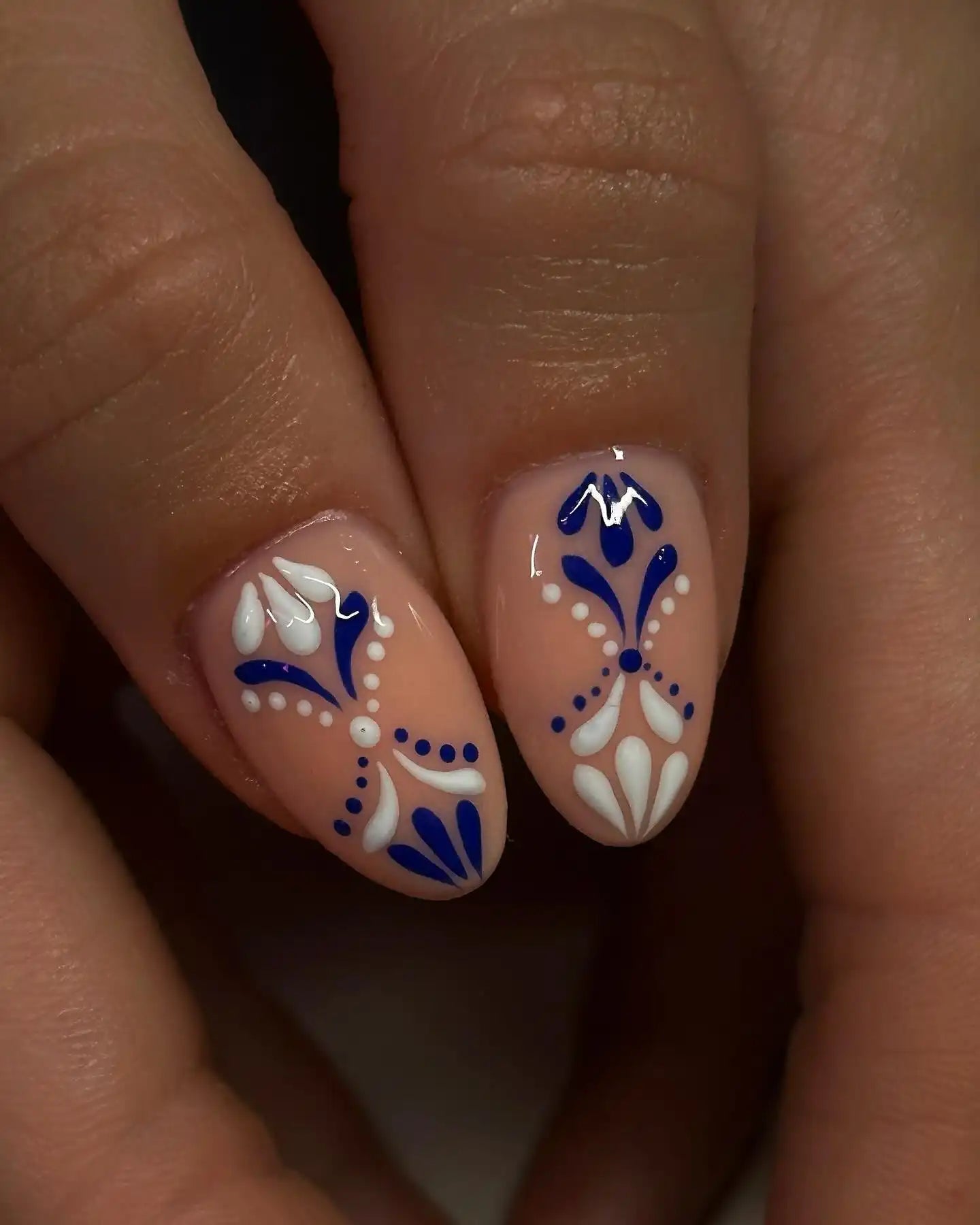 Handmade press-on nails with blue and white floral porcelain-inspired art design.