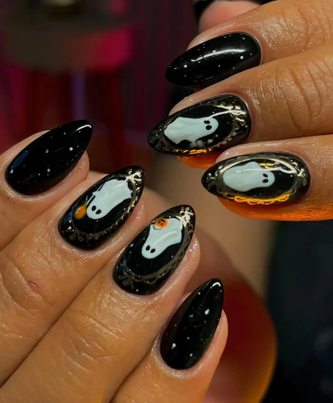 Handmade black press-on nails with cute Halloween ghost and metallic accent designs