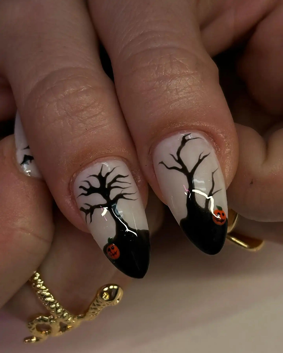 Handmade Halloween press-on nails with ghost, bat, and gold frame designs on almond tips