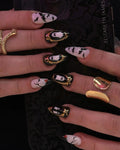 Handmade Halloween press-on nails with ghost, bat, and gold frame designs on long nails.