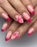Handmade hot pink French tip press-on nails with 3D floral and glitter accents