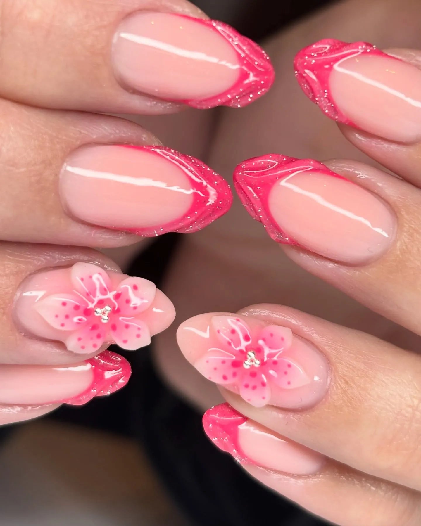 Handmade hot pink French tip press-on nails with 3D floral and glitter accents