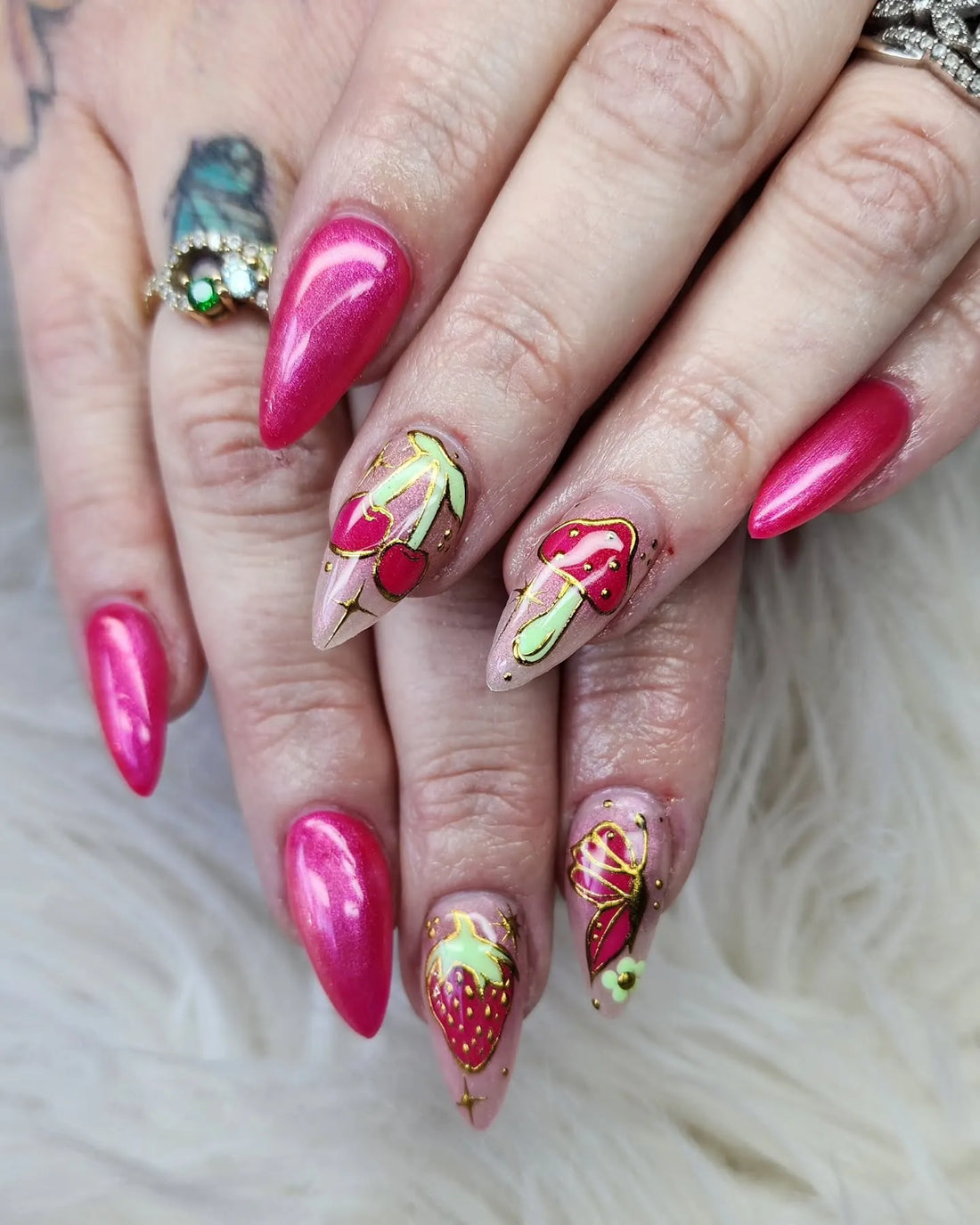 Handmade hot pink press-on nails with strawberry, cherry, butterfly, and sparkle designs