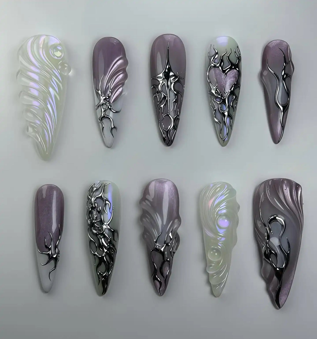 Handmade iridescent chrome purple abstract press-on nails with heart and metallic swirl designs