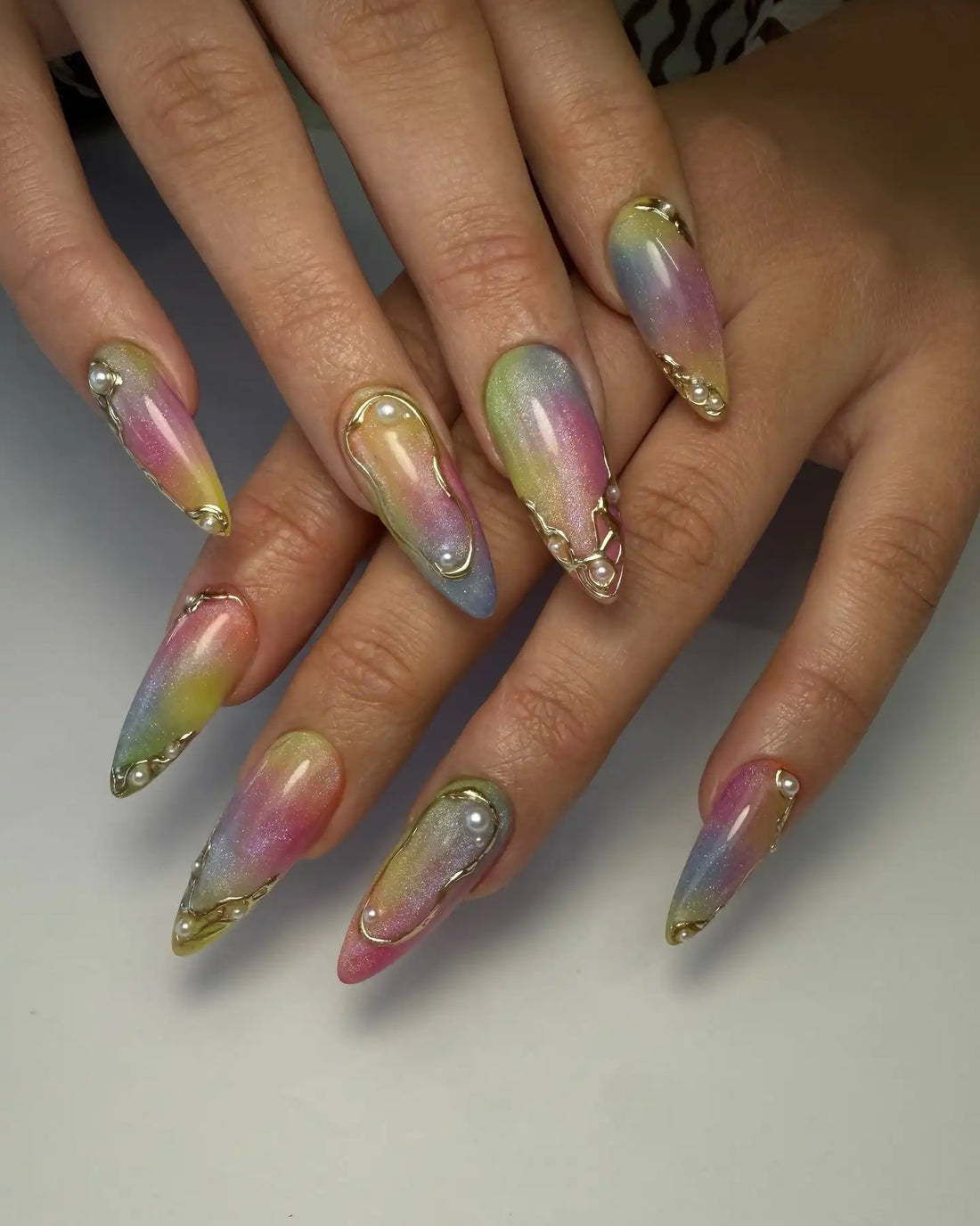 Handmade iridescent pastel press-on nails with 3D pearl and gold molten accents