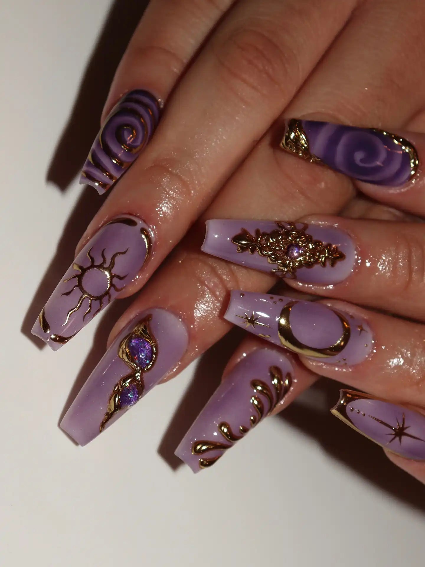 Handmade lavender press-on nails with gold celestial moon and star designs