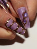 Handmade lavender press-on nails with gold accents and celestial gem designs