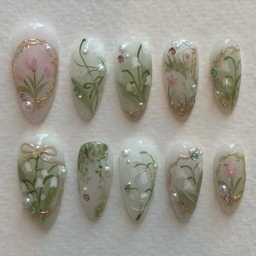 Handmade press-on nails with lily of the valley, tulip, pearl, and gold spring floral designs