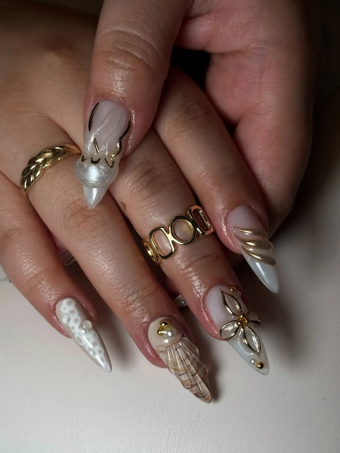 Handmade coastal press-on nails with 3D starfish, seashell, and pearl decorations