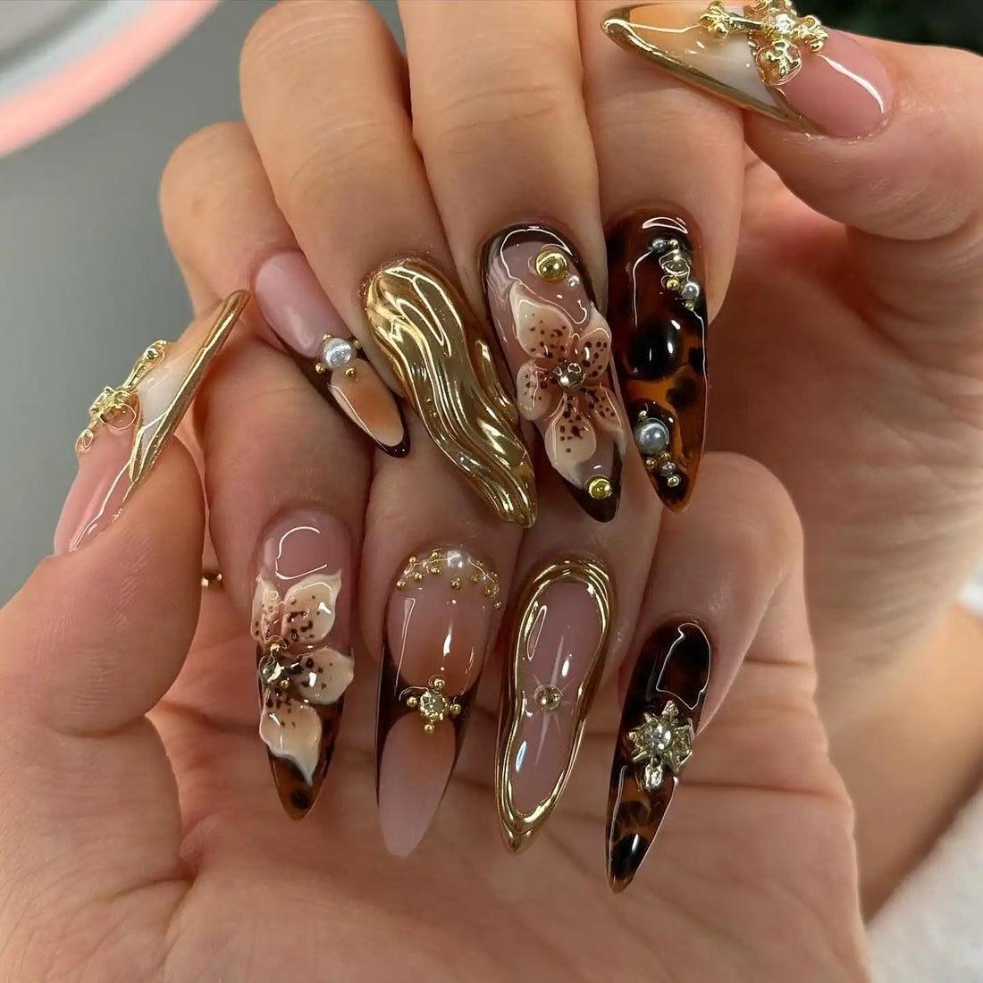 Handmade luxury 3D floral press-on nails with gold accents, pearls, and tortoiseshell tips