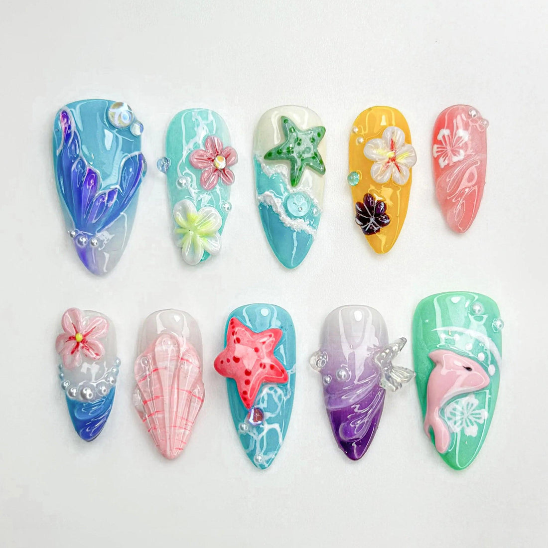 Handmade summer ocean-themed press-on nails with 3D starfish, flowers, seashell, and dolphin designs.