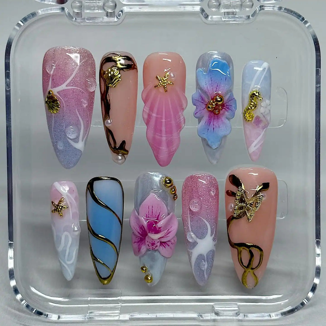 Handmade pastel press-on nails with seashell, starfish, seahorse, and floral ocean designs